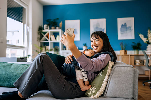 istock Mother taking selfie with her sleeping baby at home 2223042350