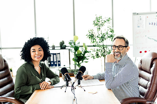 istock Two professionals collaborate on a podcast in a modern office workspace showcasing diversity and teamwork 2223043538