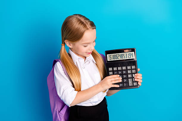 istock Young student holding a large calculator, posing against bright blue background, concept of mathematics, education 2223045713