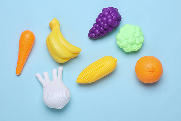 istock Set of toy plastic vegetables on blue background 2223045963