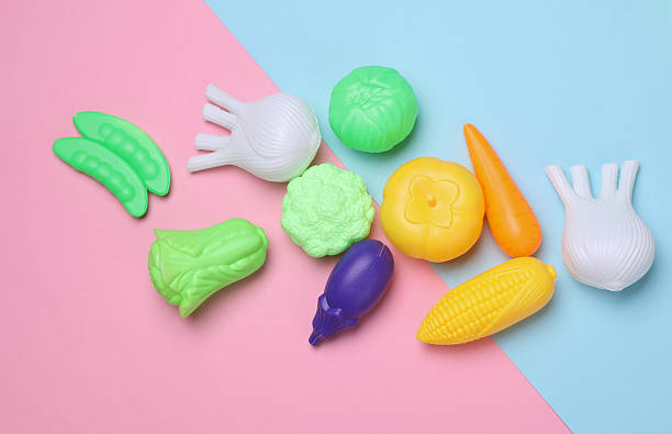 istock Set of toy plastic vegetables on blue pink background 2223045977