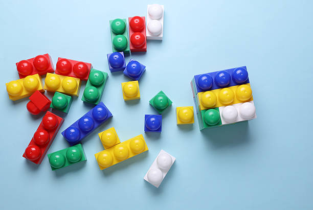 istock Multicolored plastic cubes of children's construction set on blue background 2223046016