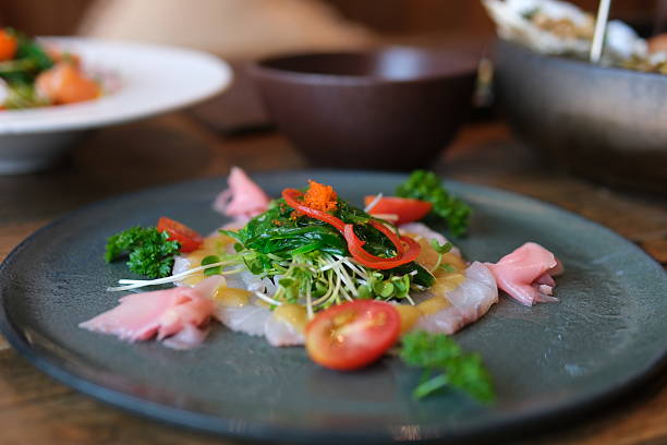 istock Salad plate vegetables Boiled white rice with salted red fish, cucumbers and other vegetables with herbs in a plate. 2223047340