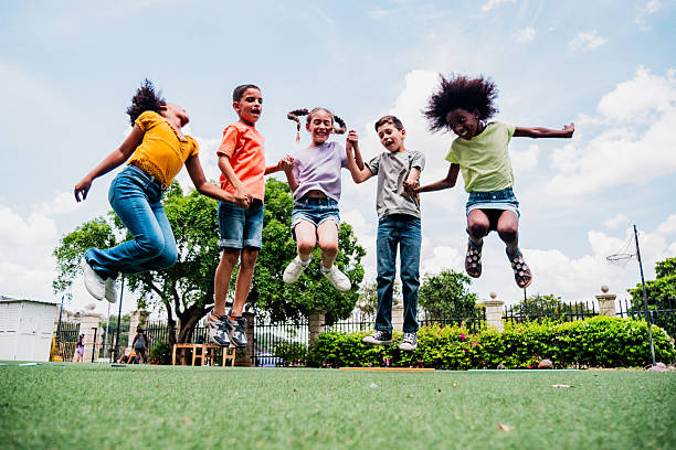 Child friends jumping on public park