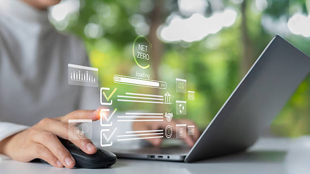 istock A person working on a laptop with a digital infographic showing progress to Net Zero emissions by 2050, ESG icons, a sustainability checklist, green technology, and climate action concept. 2223048050