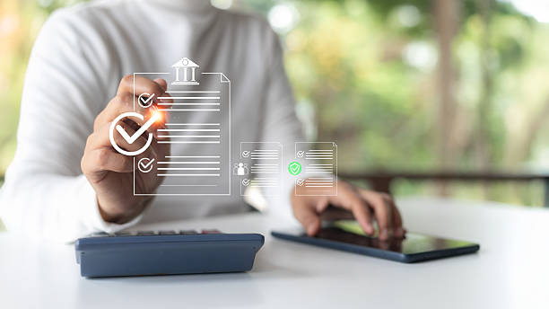 istock A person using a tablet and calculator, interacting with a digital checklist and document approval system. Concept of paperless, e-document, task management, and fintech. 2223048058