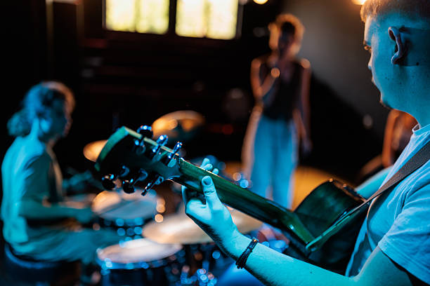 istock Guitarist leading the band on stage 2223048723