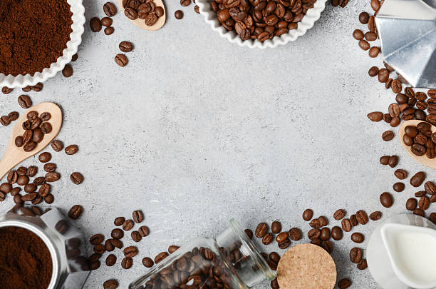 istock Coffee preparation scene with ground coffee, beans, and brewing equipment arranged artistically on a textured surface with copy space for design 2223049783