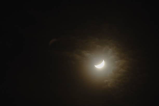 istock half moon covering by cloud floating on sky in night 2223051934