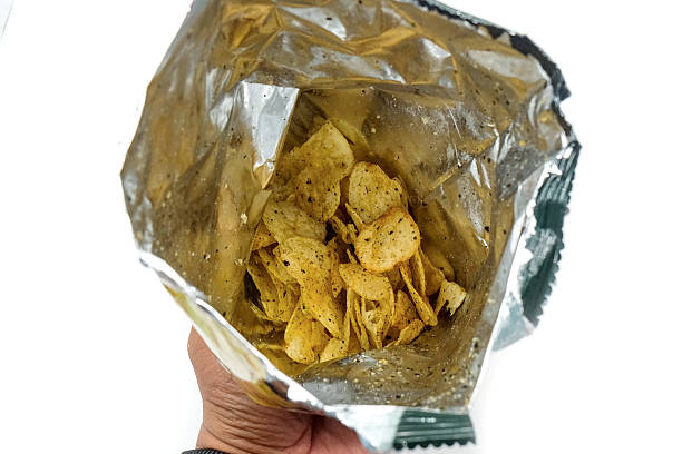 istock hands holding, potato chips with seaweed flavor isolated on white background 2223052653