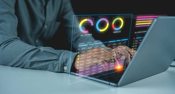 istock A person interacts with a laptop displaying futuristic data charts and analytics in a digital holographic interface. 2223054724