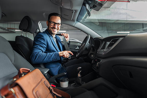 Smiling Businessman Fastening Seatbelt Inside Modern Car Interior