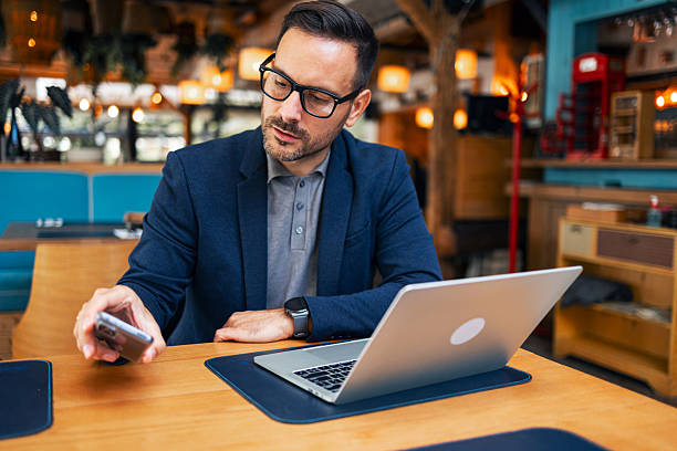 istock Professional Man Working on Laptop in Stylish Cafe Setting 2223061648
