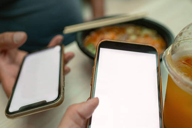 istock Couple with smart phones in a cafe 2223061944