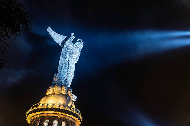 The virgin of el panecillo statue, a famous landmark, stands tall against the night sky in quito, ecuador