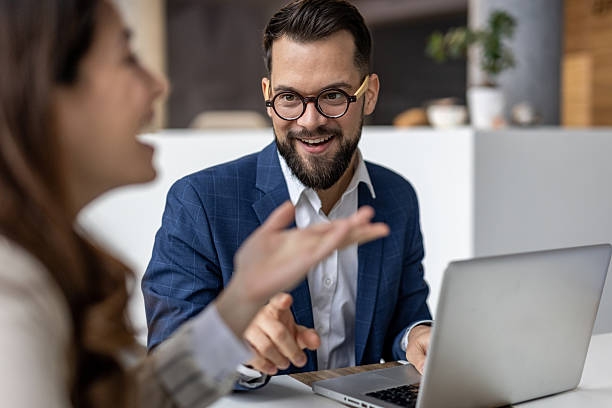 istock Businessman explaining strategy to colleague using laptop 2223067823