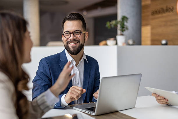 istock Businessman gesturing while talking to coworker in office 2223068645
