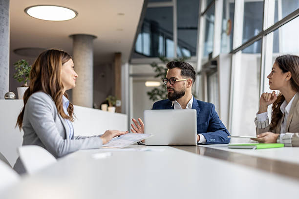 istock Businesspeople discussing work with laptop in modern office 2223069316