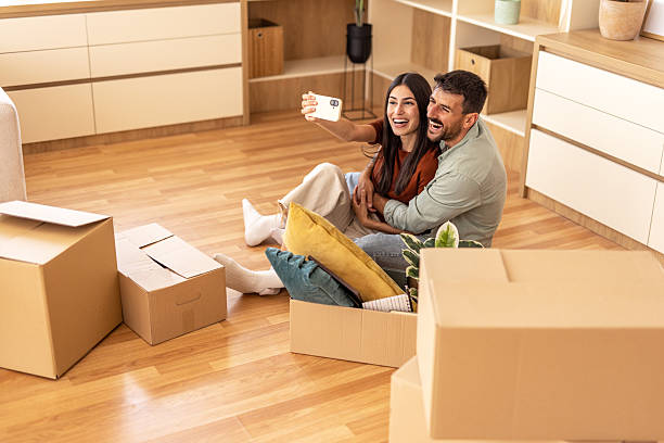 istock Young couple taking selfie while moving into new home 2223070527