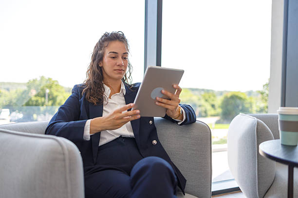 istock Businesswoman using digital tablet in modern office lobby 2223071934