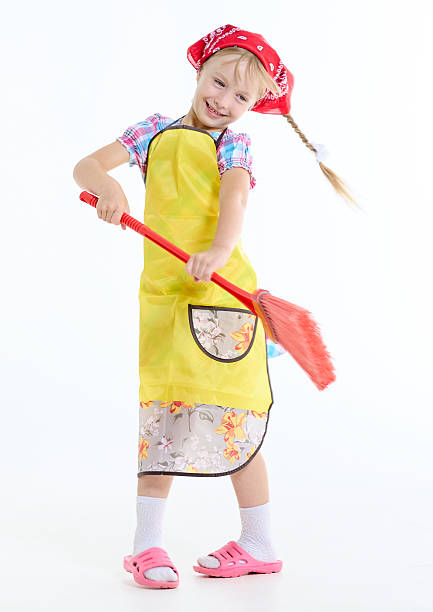 istock Cheerful girl is waving a floor broom 2223073030