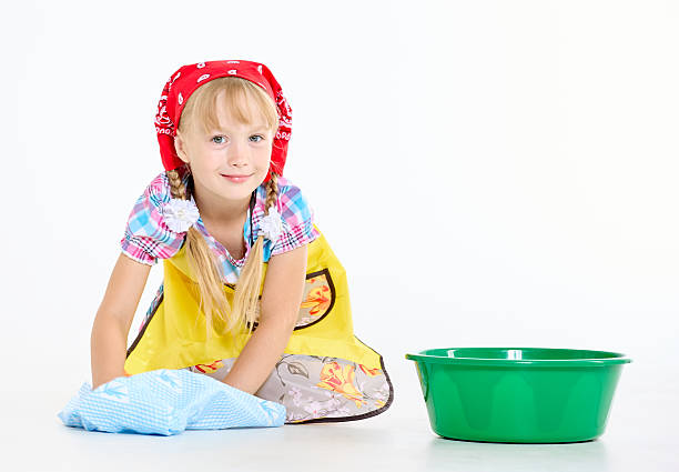 Cheerful girl working with plastic basins for water. Studio shot on white background