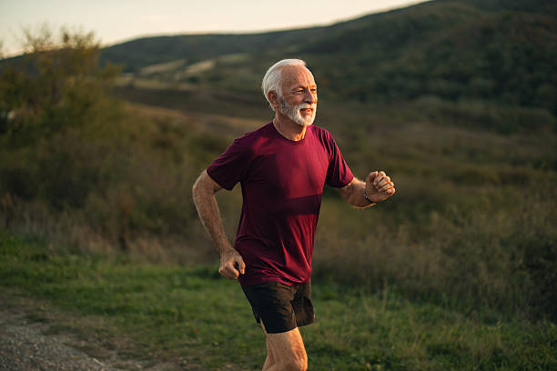istock Senior Man Jogging in Nature at Sunset 2223075157