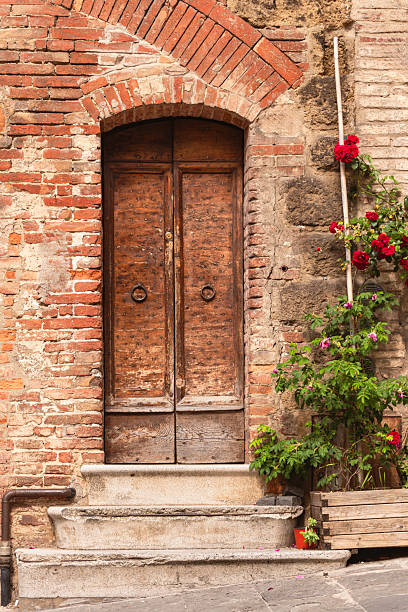 istock Beautiful Antique Door Flanked By A Red Rose 2223075861