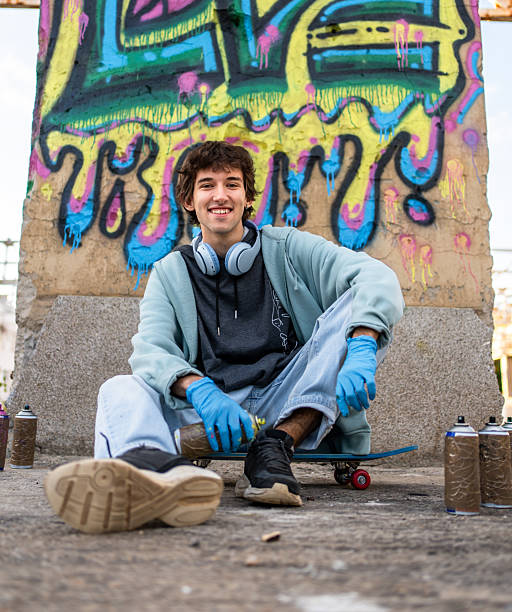 istock Young male graffiti artist taking a break on his skateboard 2223076518
