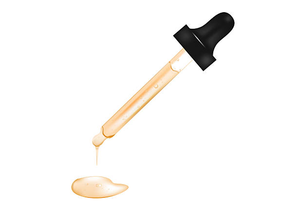 Drop of serum falls from glass pipette on white background