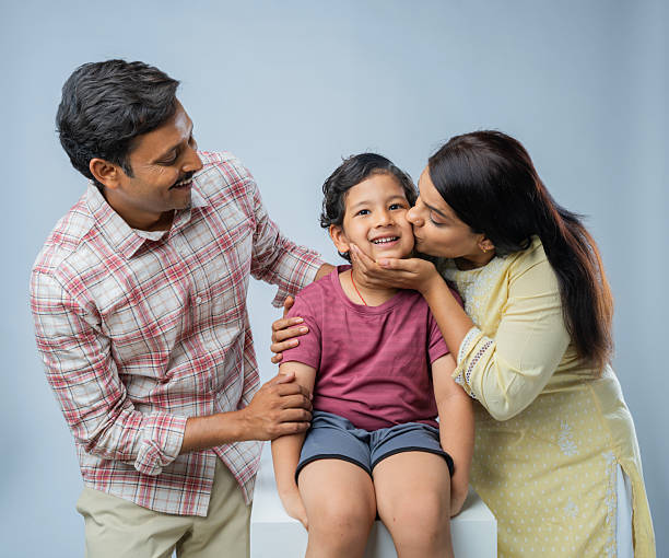 istock Parents with cute son posing on white background 2223077465