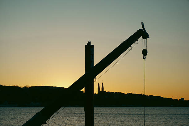 Cranes at construction site.  Building site at  Sunset view with colorful  vibrant cloud sky