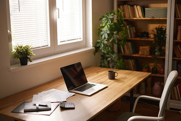 istock Comfortable home office setup with laptop and documents on desk 2223078045