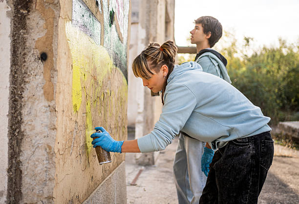 istock Young artists painting graffiti on a ruined building wall 2223078631
