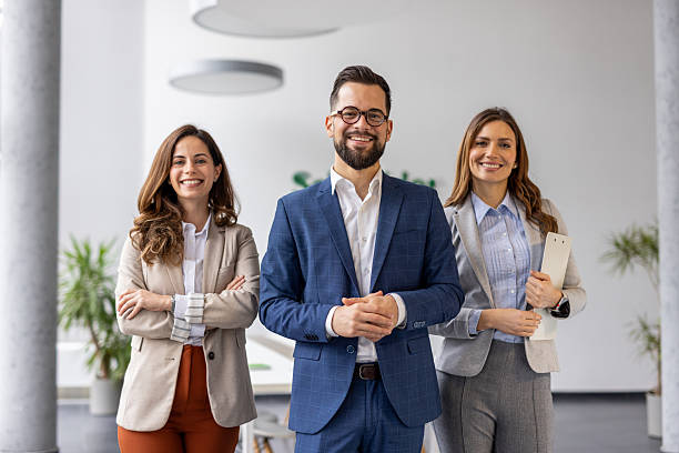 istock Smiling business team posing together in modern office 2223079961