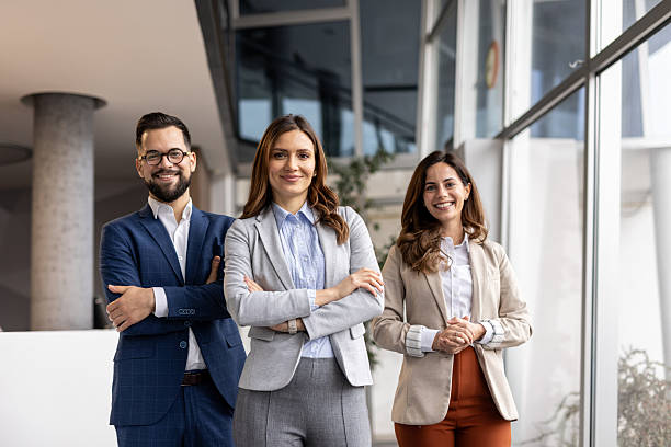 istock Business team smiling at the camera in modern office 2223080450