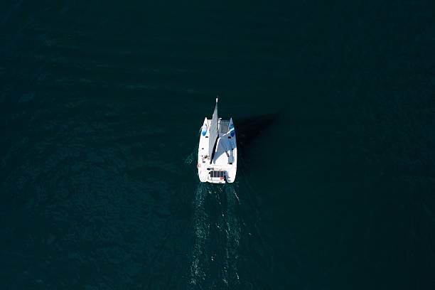 istock Aerial view of a sailboat in deep blue waters. 2223080667