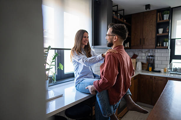 istock Young couple sharing a playful moment in their modern kitchen 2223083194