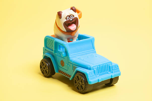 istock Toy car suv with dog on yellow background. 2223083504