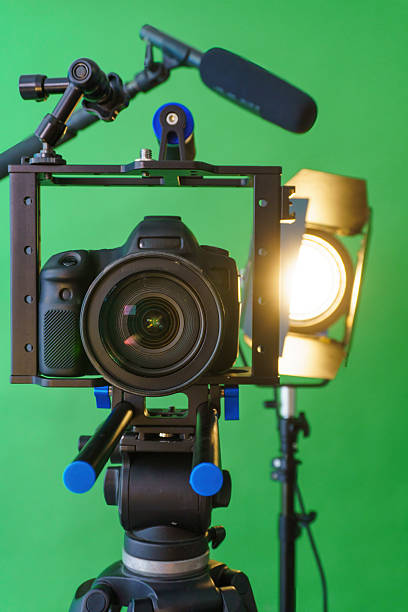 istock Professional camera setup is recording a video on green screen background 2223083609