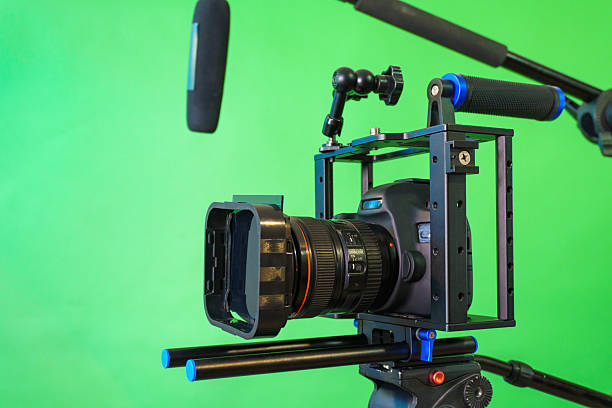 istock Professional video camera recording with green screen background 2223083652