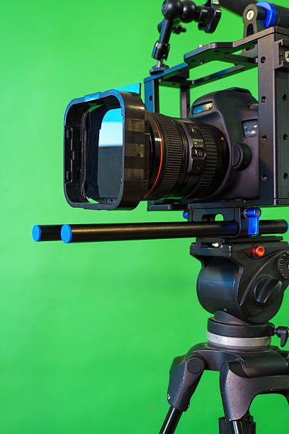istock Professional dslr camera recording video on green screen background 2223083669