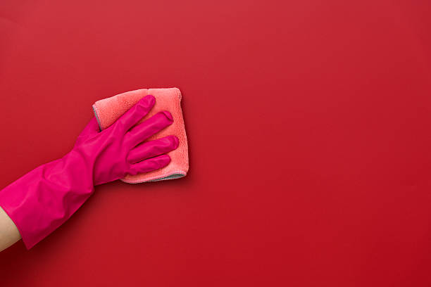 istock Woman hand cleaning red wall with rag 2223084394