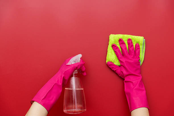 istock Woman hand cleaning red wall with rag 2223084404
