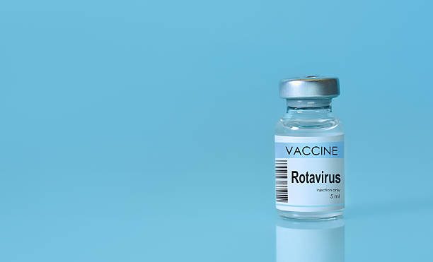 istock Rotavirus vaccine bottle placed on a clean blue background, symbolizing disease prevention, immunization, medical research, and public healthcare awareness. Banner format with copy space 2223084919