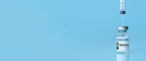 istock Rotavirus vaccine bottle and syringe placed on a clean blue background, representing healthcare, medical science, immunization awareness, and disease prevention. Banner with copy space 2223085042