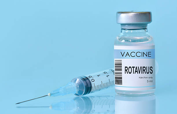 istock Rotavirus vaccine bottle and syringe placed on a clean blue background, representing healthcare, medical science, immunization awareness, and disease prevention. Banner with copy space 2223085077