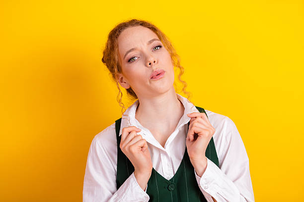 istock Young student with expressive gesture against vibrant yellow background showcasing modern casual educational theme 2223086969