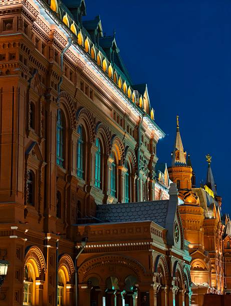 Moscow, Russia - June 28, 2025: Historical buildings in Moscow, illuminated at night. Kremlin Tower is visible on background