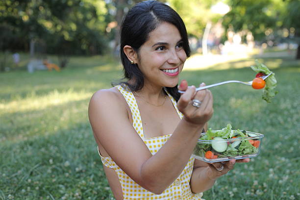istock Woman eating a salad 2223089622
